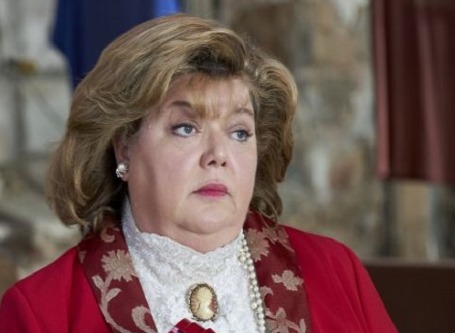 Picture of Catherine Disher Posing for a photoshoot wearing red blazer